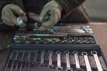 Close up wrench set and worker hands
