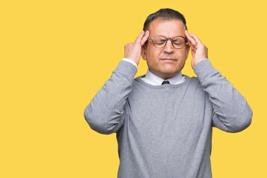 Middle age bussines arab man wearing glasses over isolated background with hand on head for pain in head because stress. Suffering migraine.