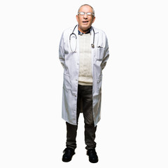 Fototapeta premium Handsome senior doctor man wearing medical coat winking looking at the camera with sexy expression, cheerful and happy face.