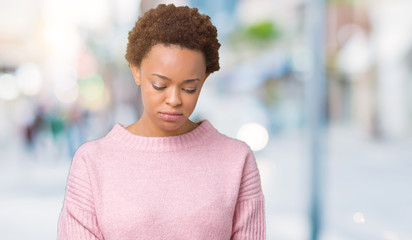 Beautiful young african american woman over isolated background depressed and worry for distress, crying angry and afraid. Sad expression.