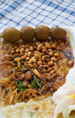 Bubur ayam is a porridge mixed with chicken meat served with egg and vegetables - Image