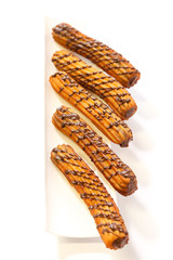 spanish chocolate fritters on a white dish with white background