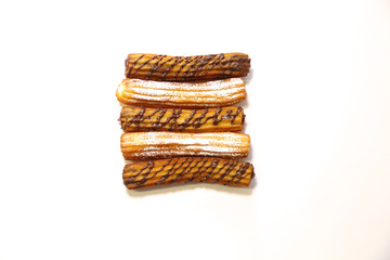 spanish chocolate and sugar fritters with white background