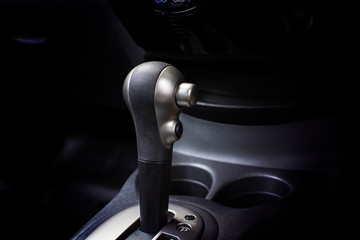 Obraz na płótnie Canvas Gear stick knob with unlock button of automatic transmission car, automotive part concept.