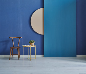 Wooden chair, coffee table and blue wall background and interior concept.