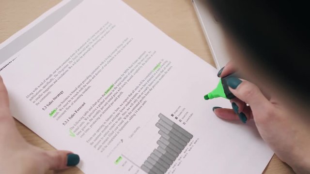 Woman holding document and identifies important text marker