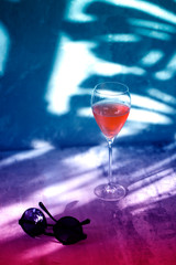 Glass of wine on a purple background. neon wineglass.