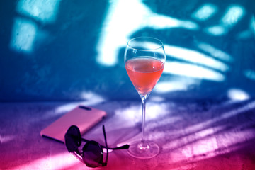 Glass of wine on a purple background. neon wineglass.