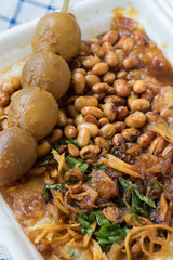 Bubur ayam is a porridge mixed with chicken meat served with egg and vegetables - Image