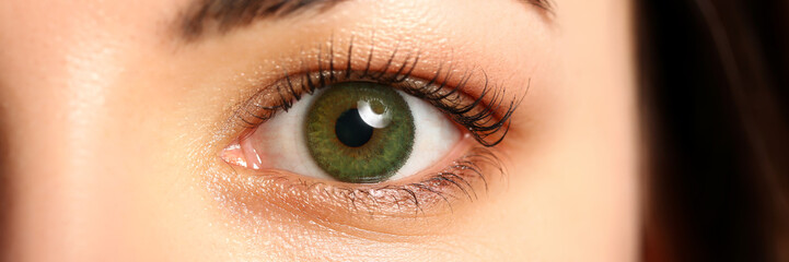 Female left emerald green coloured eye extreme closeup