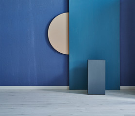 Dark blue room, brown wooden round object on the wall and blue table.