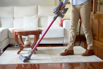 Man running a cordless vacuum
