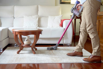 Fototapeta premium Man running a cordless vacuum