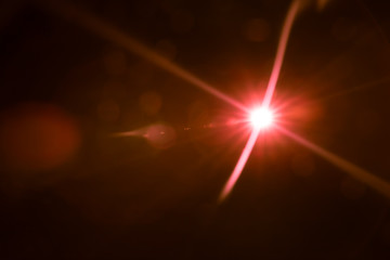 abstract lens flare red light over black background