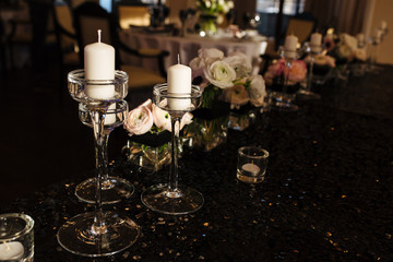 Wedding decor. Reception. Table number 1 on black wooden stand. Glasses and cutlery on side. Steampunk style