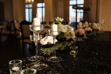Wedding decor. Reception. Table number 1 on black wooden stand. Glasses and cutlery on side. Steampunk style