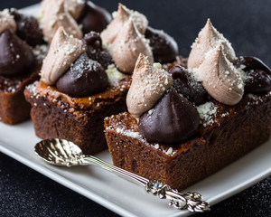 Triple Chocolate Torte on a white dish with dark background
