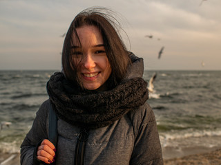 portraits young attractive girl on the background of the sea, sky and gulls