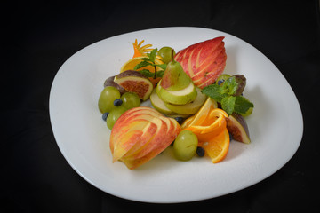 fruit plate on black background
