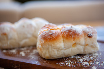 Fresh bread on a wooden plate
