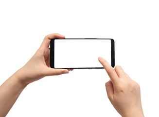 Close up of female hands holding and pointing horizontal mobile smart phone with white blank screen isolated on white background. Mock up. Copy space.