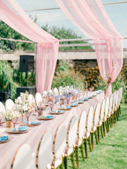 Table setting at a luxury wedding reception. Outdoor wedding