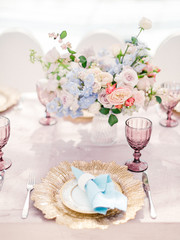 Table setting at a luxury wedding reception. Outdoor wedding