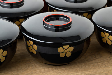 Row of traditional black lacquered Japanese bowls
