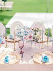 Table setting at a luxury wedding reception. Outdoor wedding