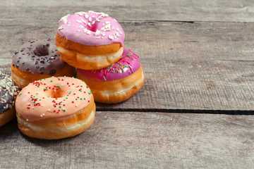 Glazed donuts on wooden background