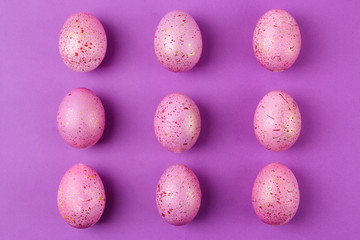 Easter. Pink Easter eggs on trendy purple background. Happy easter. holidays. top view