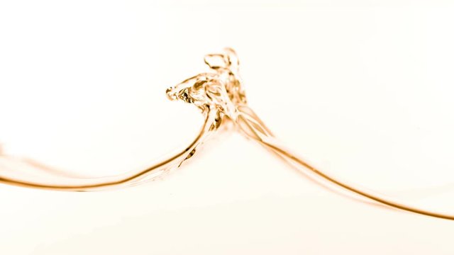 Super slow motion of splashing cola/whiskey/tea isolated on white background. Filmed on very high speed camera, 1000 fps.