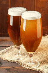 Glass beer on wood background