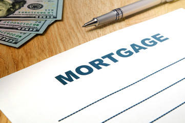 Fototapeta premium Mortgage with a pen, money on the table.