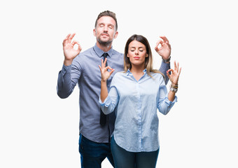 Young workers business couple over isolated background relax and smiling with eyes closed doing meditation gesture with fingers. Yoga concept.