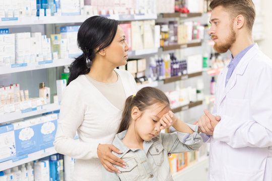 Professional pharmacist helping his customers