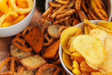 Beer snacks on stone and wooden background. Top view, copy space