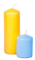 Colored candles of different size on white background