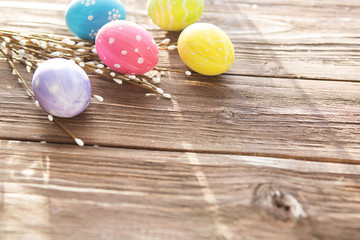 Easter egg with willow branches on wooden background