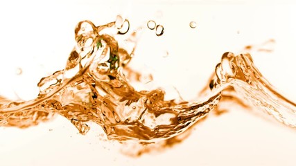 Super slow motion of splashing cola/whiskey/tea isolated on white background. Filmed on very high speed camera, 1000 fps.