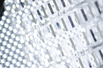 Abstract high-tech geometrical background. A sheet of transparent plastic or glass with the cut out holes. Laser cutting of plexiglass or 3d printing.