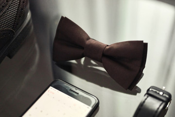 different accessories of a businessman for creating a style of a people lie on a wooden background