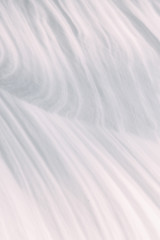 Obraz premium The wavy texture of fresh snow. White drifts and the sun.