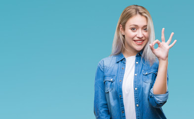 Young blonde woman over isolated background smiling positive doing ok sign with hand and fingers. Successful expression.