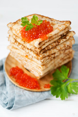 Pancakes with red caviar. Selective focus