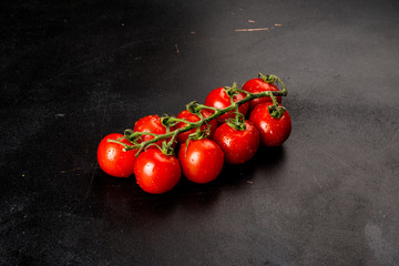 Cherry tomatoes shot on a black background