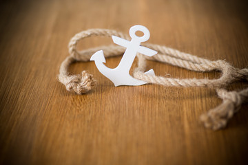 white decorative anchor on a wooden background