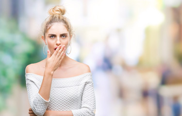 Young beautiful blonde and blue eyes woman over isolated background bored yawning tired covering mouth with hand. Restless and sleepiness.