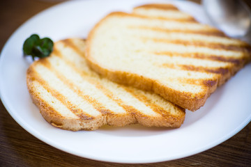 fried toast in a plate on a wooden table