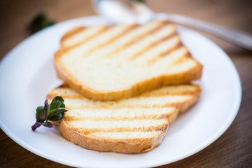 fried toast in a plate on a wooden table